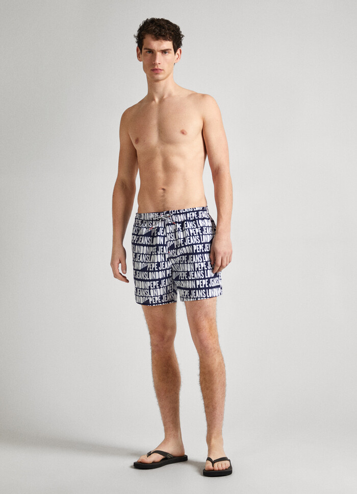 SWIM SHORTS WITH ALL-OVER LOGO PRINT